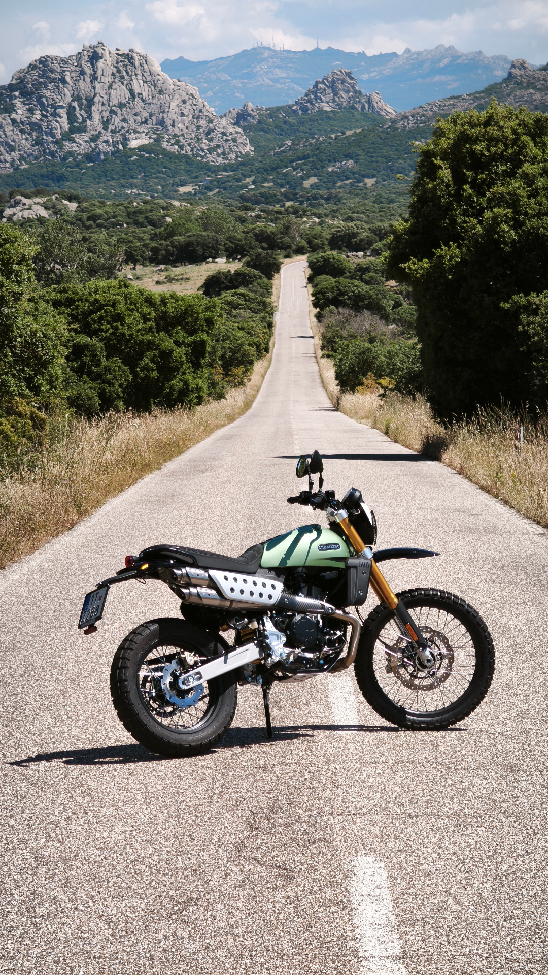 Motorcycle on Sardinian cliff at golden hour
